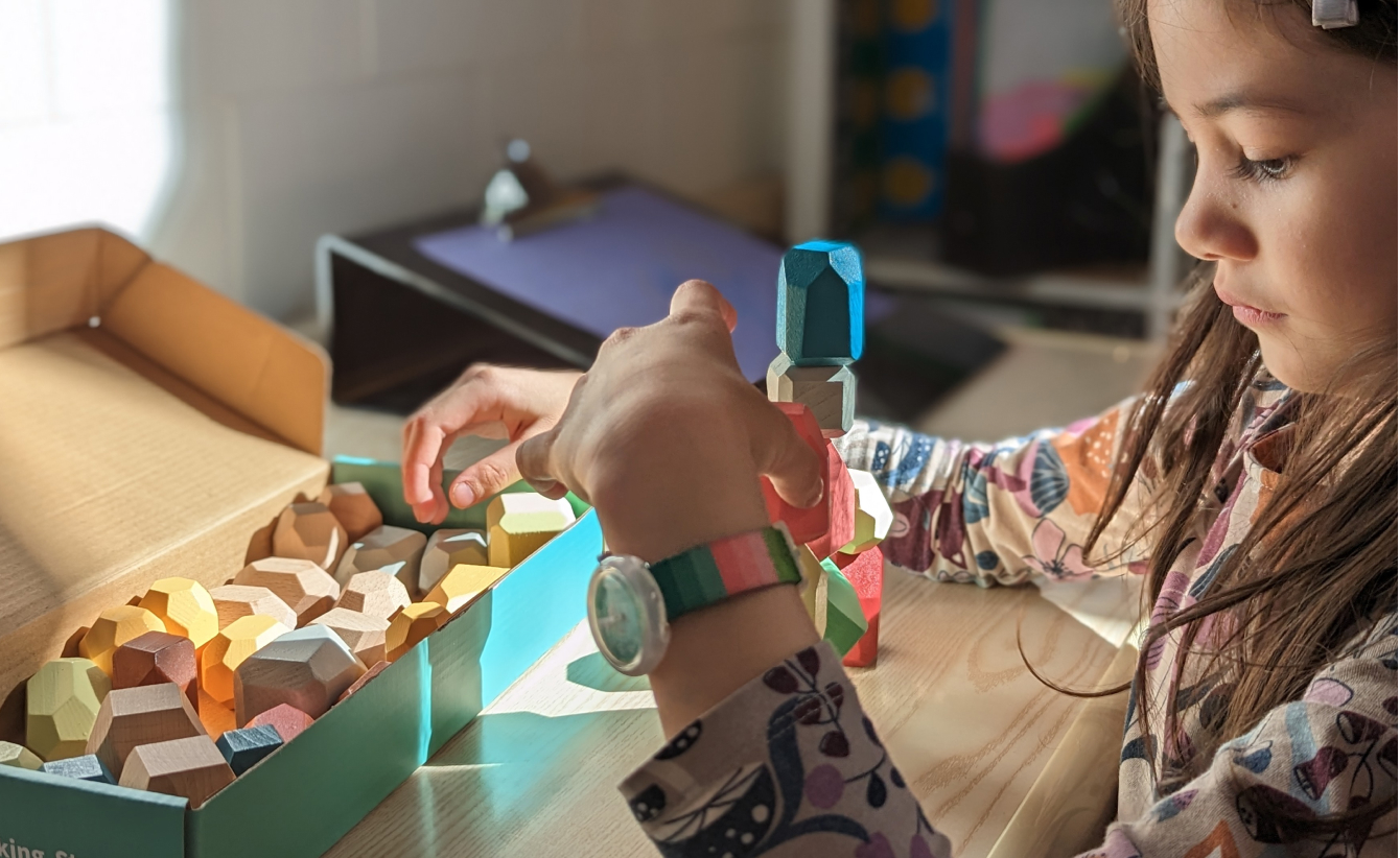 Kid working on stacking blocks